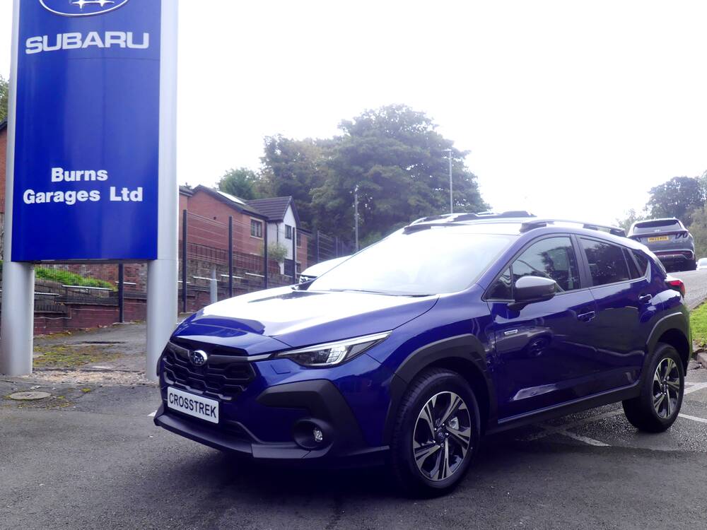 A new Subaru Crosstrek in Sapphire Blue on the Burns Garages forecourt